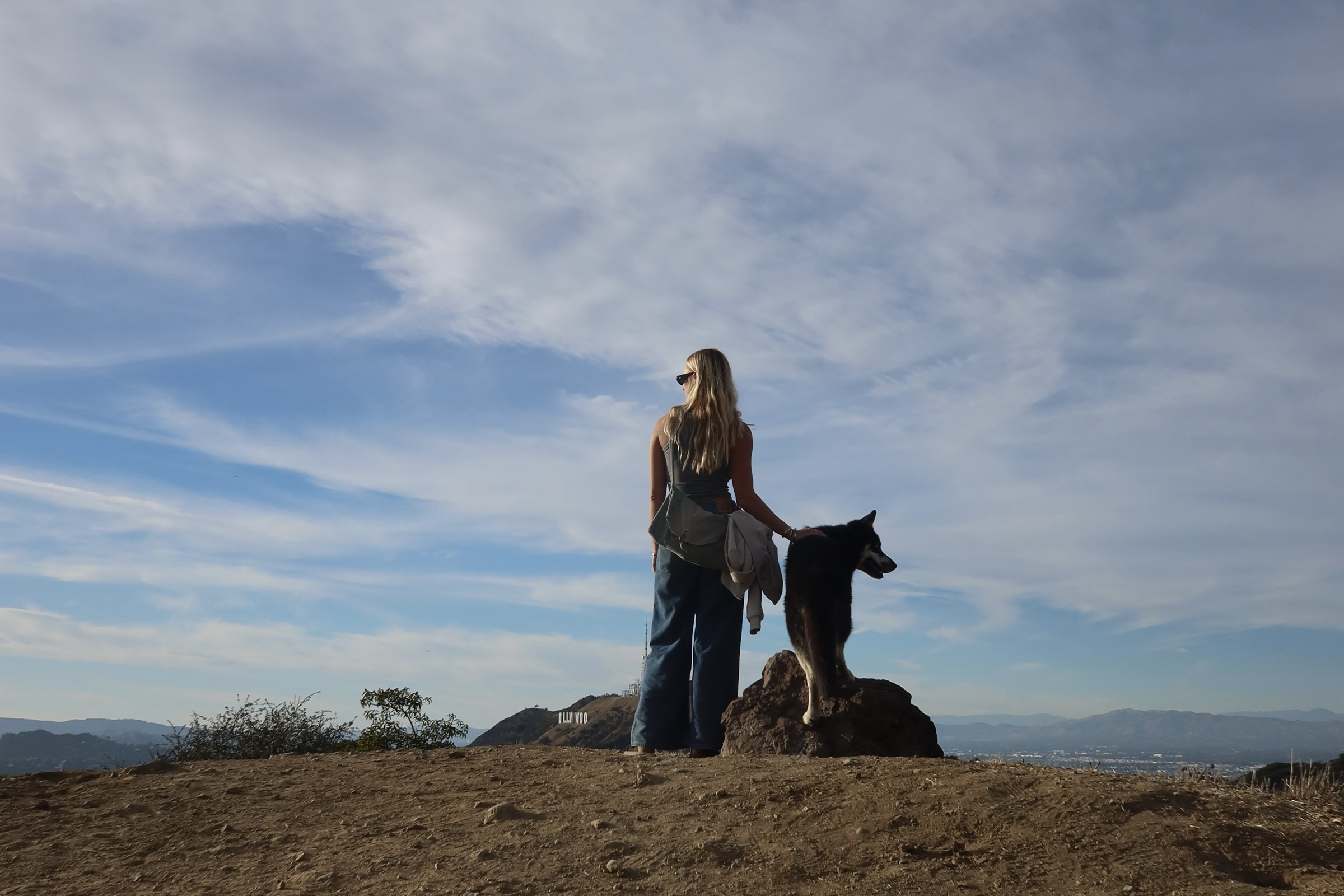 Christina Osborne and her dog looking out over a hillside