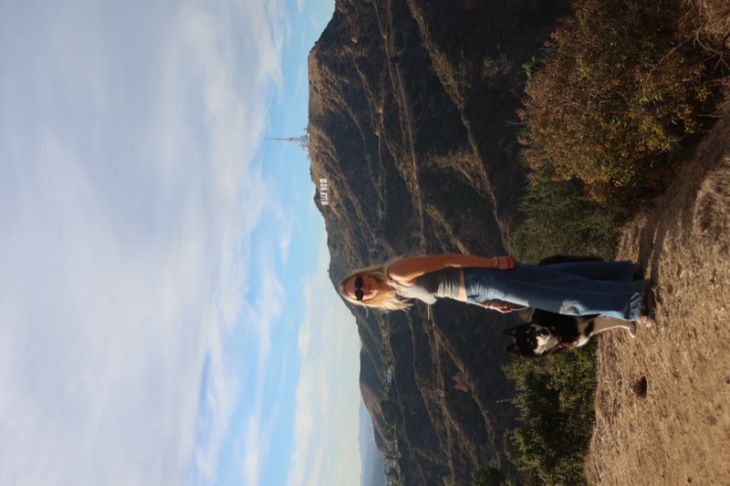 Christina and her dog together on a hilltop